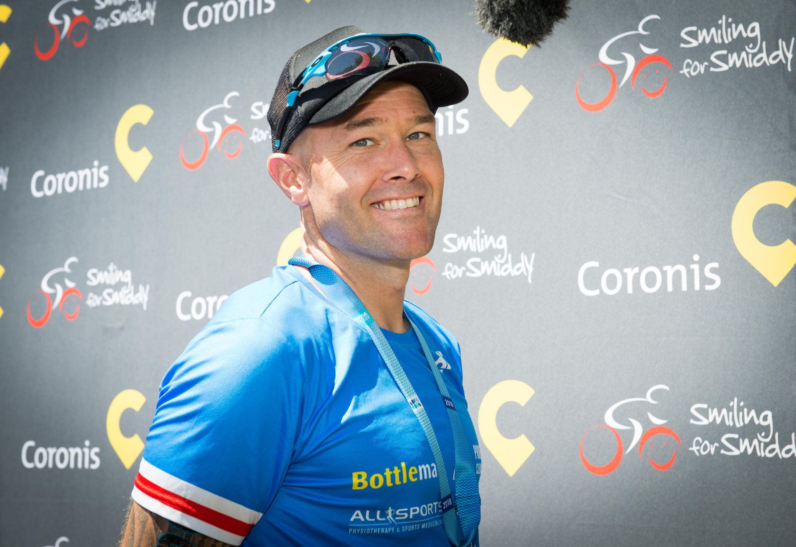 Tom smiling in his Team Smiddy tri-suit at the 2018 Noosa Triathlon.